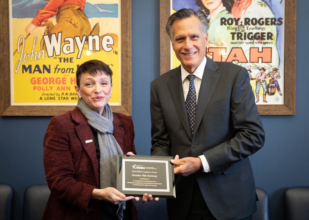 Kathy Holder presents Senator Romney with an award.
